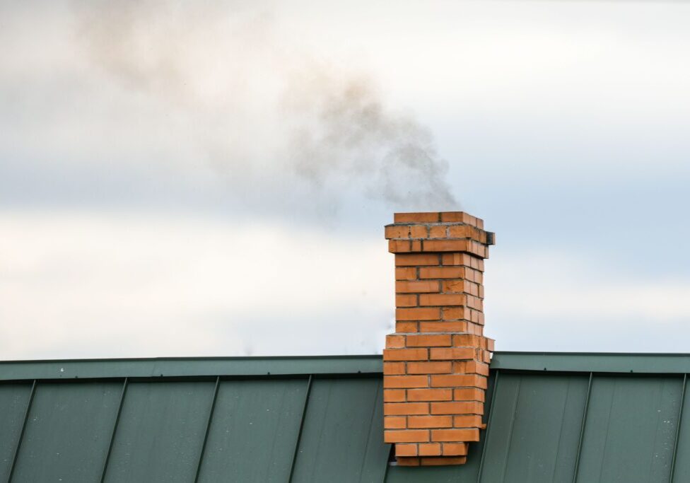 smoke-from-chimney-heating-smoke-billowing-coming-out-house-chimney-against-blue-sky-background smoke-from-chimney-heating-smoke-billowing-coming-out-house-chimney-against-blue-sky-background